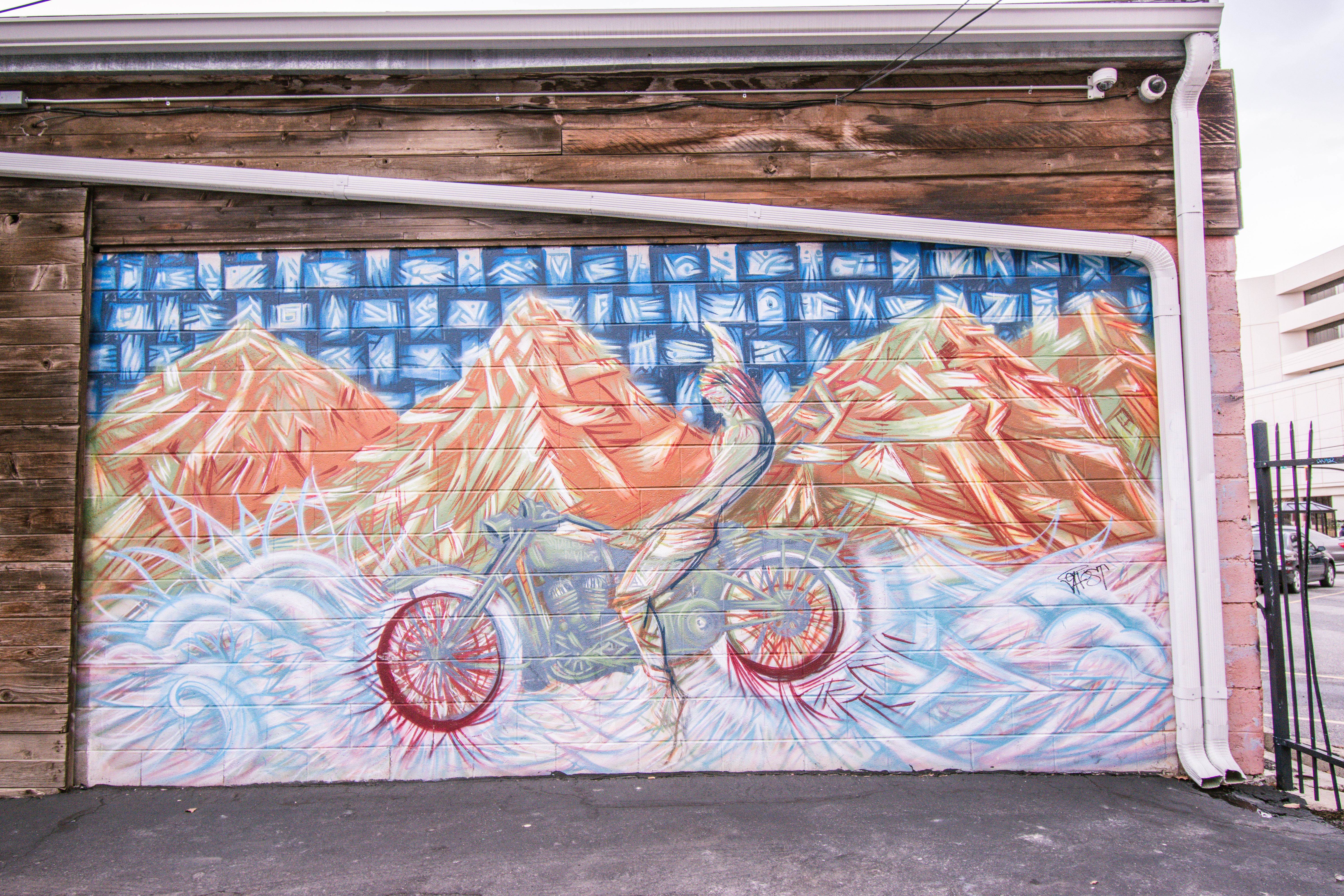 Street art in Salt Lake City, being riding motorcycle in mountains